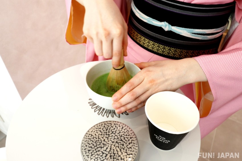 A woman preparing matcha